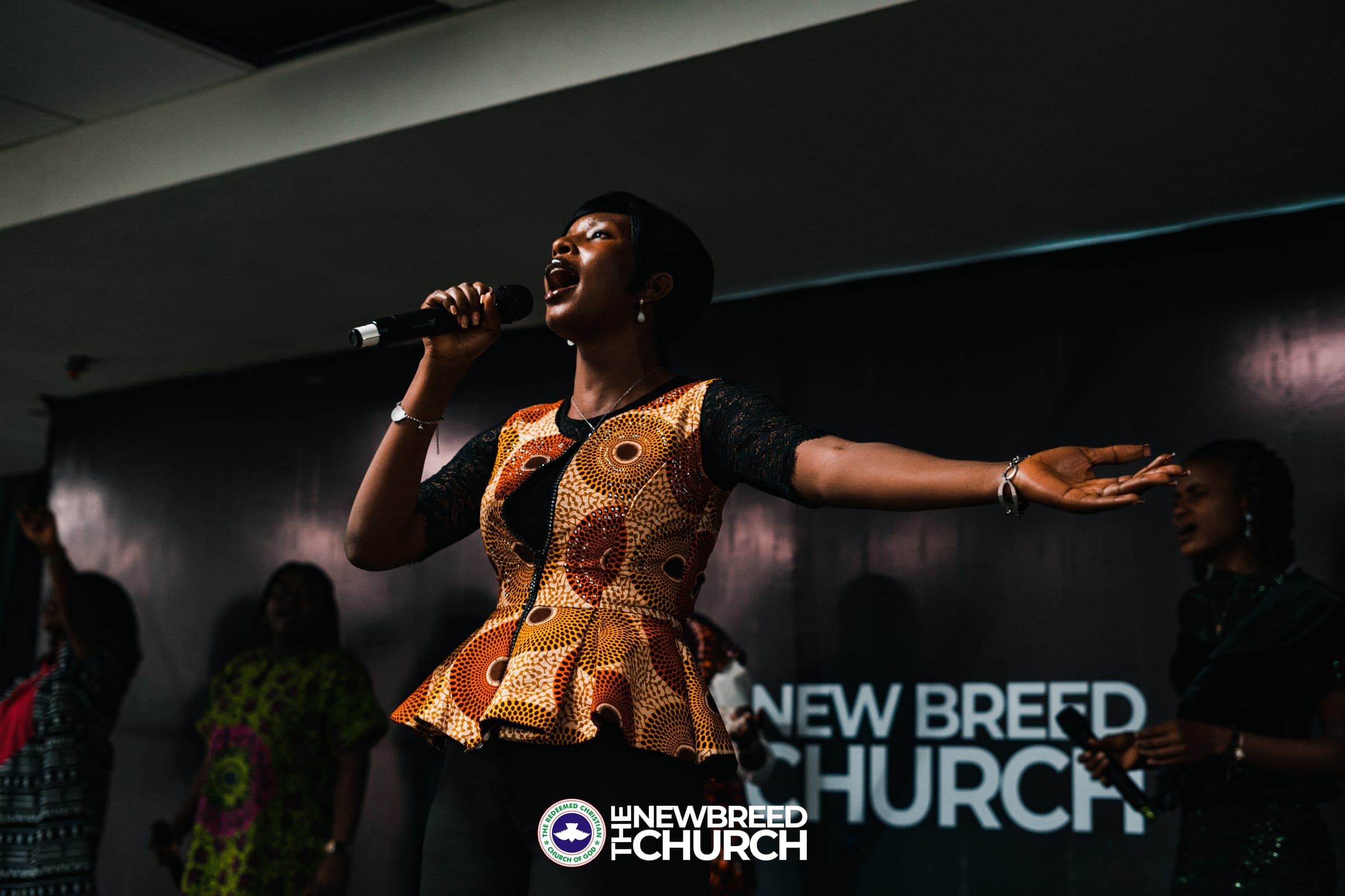 Worship vocalist leading praise at The New Breed Church